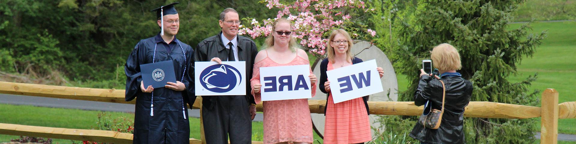 Graduate poses with family for photo